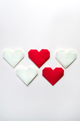 Handcraft paper red and white hearts on gray background with copy space for text. Creative layout for your ideas.