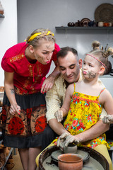 master class in a pottery workshop for a family