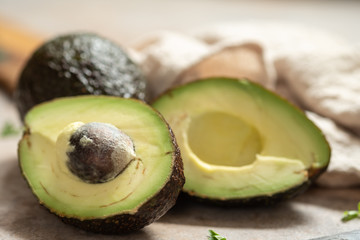 Fresh sliced avocado on wooden table. Vegetarian food concept.