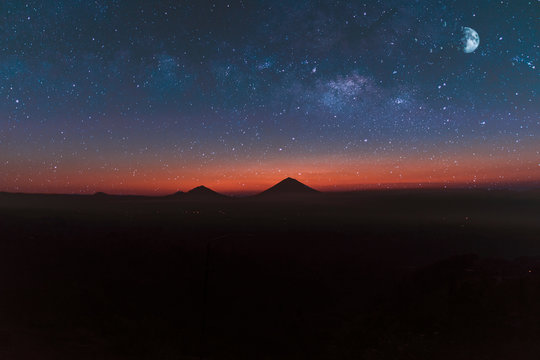 mountains under starry sky with moon
