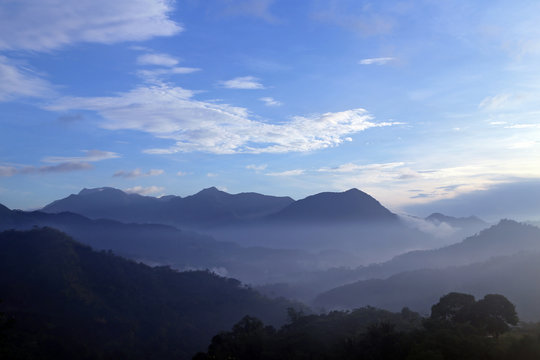 mountains covered with white clouds under blue sky