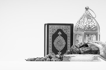 Kuala Lumpur, Malaysia - February 28, 2019 : Lantern, Dates, Koran and Rosary on white background with selective focus and crop fragment. Ramadan, Religion and Copy space concept. Black and White