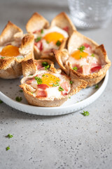 Baked egg, bacon and toast cup for breakfast brunch.
