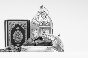 Kuala Lumpur, Malaysia - February 28, 2019 : Lantern, Dates, Koran and Rosary on white background with selective focus and crop fragment. Ramadan, Religion and Copy space concept. Black and White
