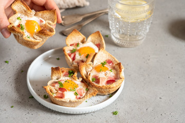 Baked egg, bacon and toast cup for breakfast brunch.