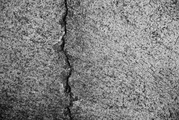 Cracked concrete floor closeup for background. Black and white.
