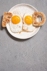 Word food written with toast letters fried eggs