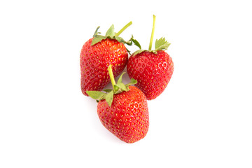 Fresh red strawberries on white floor.