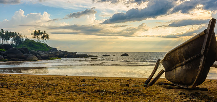 brown row boat on seashore