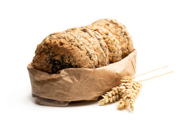 Wholemeal seeded scones on paper bag isolated on white