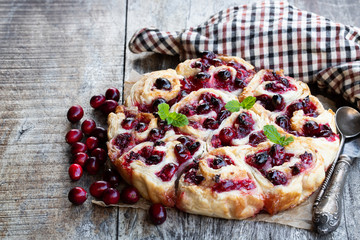 Freshly baked Cranberry buns on wooden table