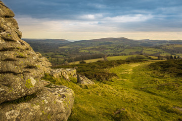 A panoramic view of Dartmoor National Park from Watern Tor, the green landscape leads into the...