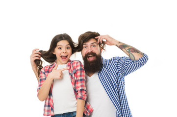 He envies my hairstyle. Man with beard and little girl long hair on white background. Father play...