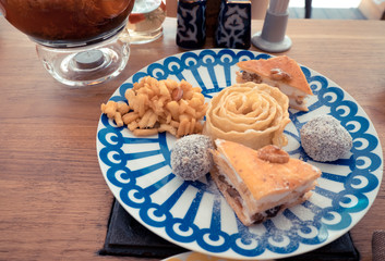 sweets Chuck, Chuck and nuts on the plate with blue triangles, the concept of dessert