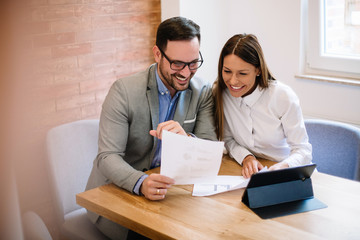 Young business couple signing a contract