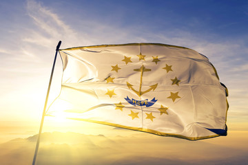 Rhode Island state of United States flag waving on the top sunrise mist fog