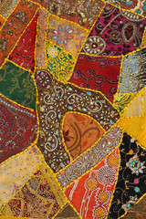 Colorful patchwork carpet with beads.Background,texture.