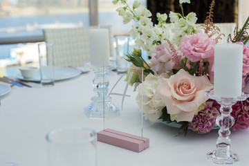 Event white restaurant table served and decorated with delicate fresh flowers