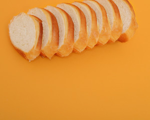 Slice of fresh bread isolated on orange background