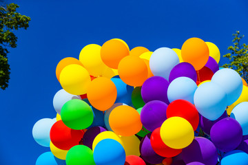 Background of a set of colored balloons on the sky background 