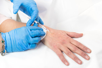 Mesotherapy process on a female hand in clinic 