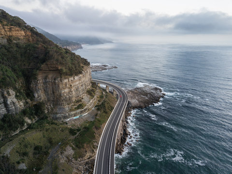 gray concrete road near sea