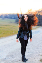 girl at sunset waving beautiful black hair