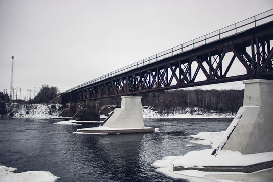 lake under metal girder bridge