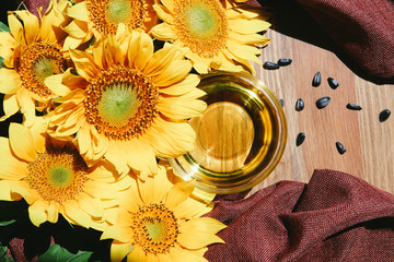 Sunflower oil with flowers, top view of food ingredient 