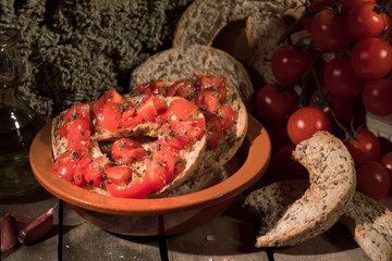 Italian starter friselle. Classical frisella with tomato, salt, oregano and olive oil. Dried bread called freselle. Tipical apulian still-life of healthy vegetarian food, close-up