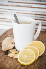 Close up of hot ginger tea on wooden table.