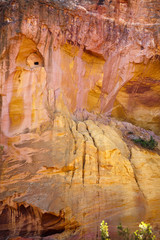 Texture of the mountains in the park "Sentiers des Ocres" near the village of Roussillon, Vaucluse, Provence, France. Vertical photo. Travel France.