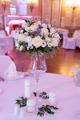 Banquet decorated table, with cutlery. Wedding decor in the banquet hall. Serving of a festive table, plate, napkin, knife, fork. Table setting decoration. Romantic Dinner or other events - wedding.