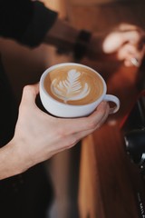 cup of coffee in hands of a man