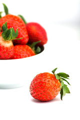 fresh strawberries in a bowl on white background