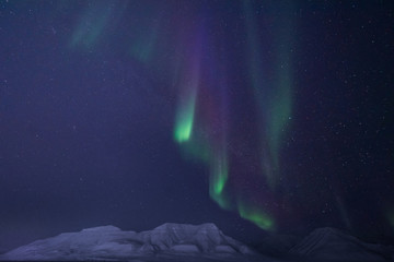 The polar arctic Northern lights aurora borealis sky star in Norway travel Svalbard in Longyearbyen city the moon mountains