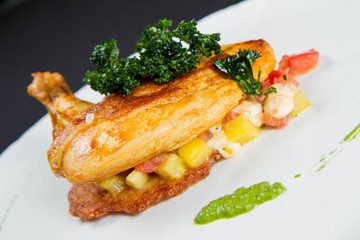 Chicken served with potato pancake some vegetables decorated with pea mash