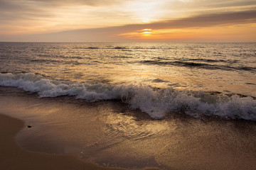 Beautiful sunset seascape with the sun and waves.