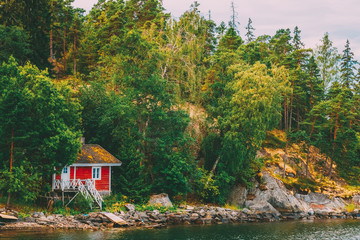 Red Finnish Wooden Bath Sauna Log Cabin On Island In Summer