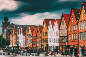 Bergen, Norway. Tourists People Visiting Historical Landmark Houses In Bryggen - Hanseatic Wharf In Bergen, Norway. UNESCO World Heritage Site. Famous Landmark