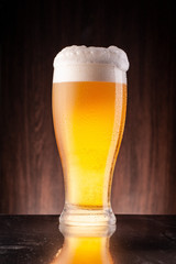 Glass beer on wood background
