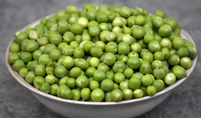 A grain of peeled young green peas