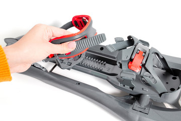 Fastener detail of snowshoes, studio shot. Winter hiking equipment.