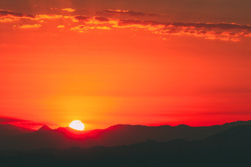 Fototapeta premium Beautiful Sunset Sunrise Over Dark Mountain Silhouette