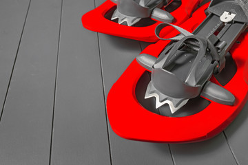 Modern red snowshoes studio shot. Winter hiking equipment.