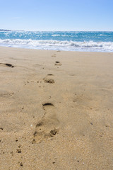 footprint on the sand coming out of the sea