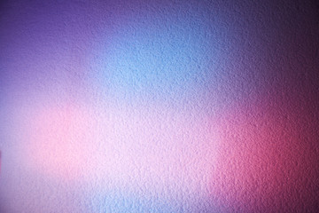 Blurred textural background of blue color with a soft pink glow