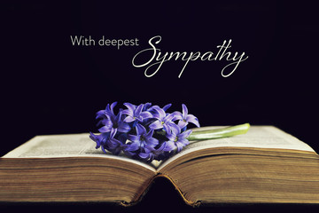 Sympathy card with flower and open book