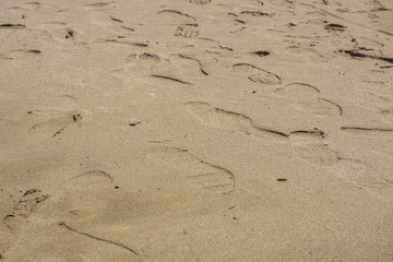 many footprints in the sea sand