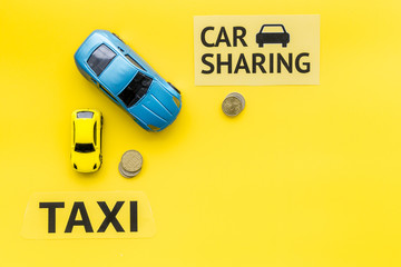 Carsharing vs taxi concept. Comparing carsharing system and taxi. Ship trip concept. Toy cars ans...